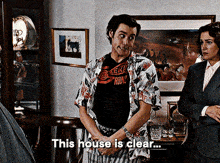 a man wearing a shirt that says ' this house is clear '