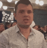 a man in a white shirt is sitting at a table
