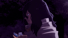 a man with long hair is looking at a cell phone that says ' 00 ' on the screen