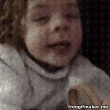 a little girl is crying while holding a banana in her mouth .