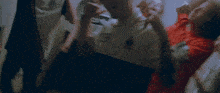 a group of people are dancing in a room and one of them has a tattoo on his arm that says ' a ' on it