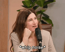 a woman sitting in front of a microphone says whip noise *