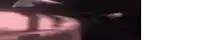a blurred image of a person standing on top of a table .