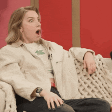 a woman sitting on a couch with her mouth wide open