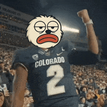 a man wearing a colorado jersey with a cartoon face on his face
