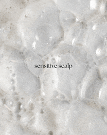 a close up of soap bubbles with the words sensitive scalp
