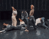 a group of people are doing a routine on a dance floor