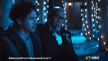 two men are standing next to each other with a nbc logo in the corner