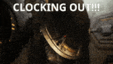 a close up of a metal object with the words clocking out written above it