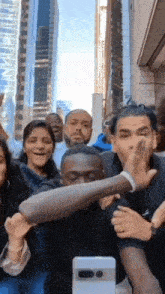 a group of people are posing for a picture in front of a building .