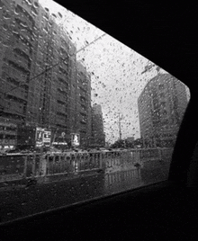 a black and white photo of rain drops on a car windshield