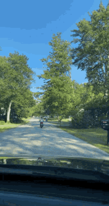 a person is riding a motorcycle down a road