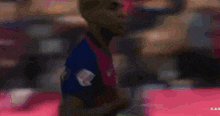 a blurry picture of a soccer player with the word real on the bottom left