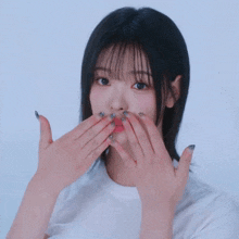 a girl with short black hair is smiling and making a funny face