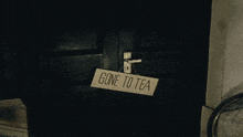 a door with a sign that says gone to tea on it