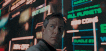 a man standing in front of a screen that says all planets