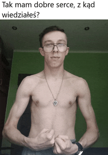 a shirtless man wearing glasses and a necklace stands in front of a green background