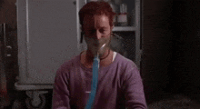 a man wearing an oxygen mask with the words `` i feel like a duck-bil '' behind him .