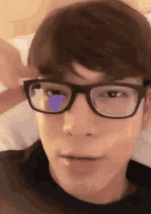 a close up of a person wearing glasses