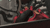 a cartoon character is riding a red motorcycle with a camera on the back