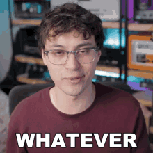 a man wearing glasses says " whatever " in front of a computer