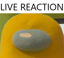 a yellow among us stuffed animal with the words live reaction written below it