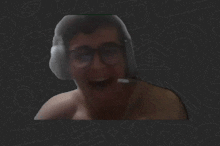 a man without a shirt is wearing headphones and a microphone