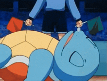 a cartoon turtle is laying on the ground with a person standing behind it holding a flag .