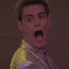 a close up of a man making a surprised face with his mouth open .