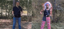 a man in a native american headdress is holding a gun next to another man in an american flag outfit