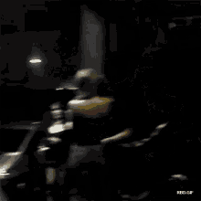 a group of people are standing in a dark room with a watermark that says rbd gif