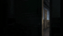 a black door with a yellow stripe on it is open to a dark room