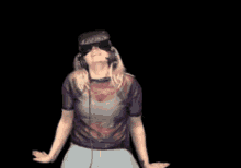 a woman wearing headphones and a virtual reality headset is dancing
