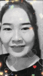 a black and white photo of a woman with hearts surrounding her face