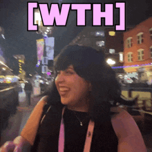a woman is smiling in front of a sign that says ' iwth '