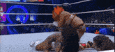 two wrestlers are wrestling in a ring with the word ee on the bottom