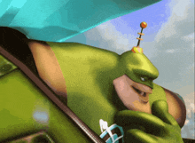 a green cartoon character with a blue umbrella on his head