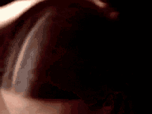 a close up of a woman 's face with her eyes closed and her mouth open .