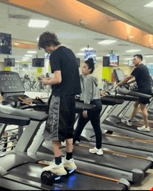 people on treadmills in a gym with one that says deck on it