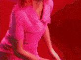 a woman in a pink dress is standing next to a cartoon figure