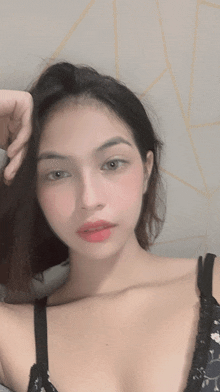 a woman in a black bra is taking a picture of herself
