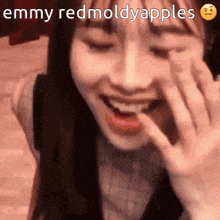 a close up of a woman 's face with the words emmy redmoldyapples written on it