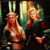 a man and a woman are standing next to each other in a forest