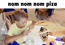 a young boy sits at a table eating a pizza with the words nom nom nom pizza above him