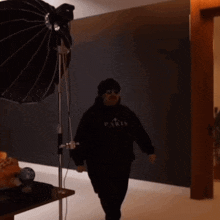 a man wearing sunglasses and a black paris hoodie