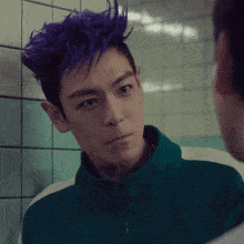 a man with purple hair and a green jacket