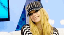 a woman wearing a hat and a striped shirt