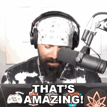 a man wearing headphones and a bandana says that 's amazing in front of a microphone