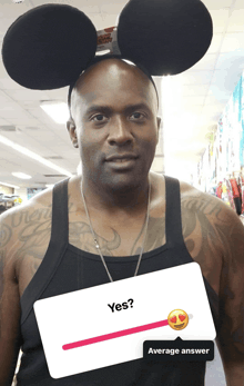 a man wearing mickey mouse ears holds a card that says yes and average answer