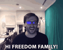 a man says hi freedom family in front of a green curtain